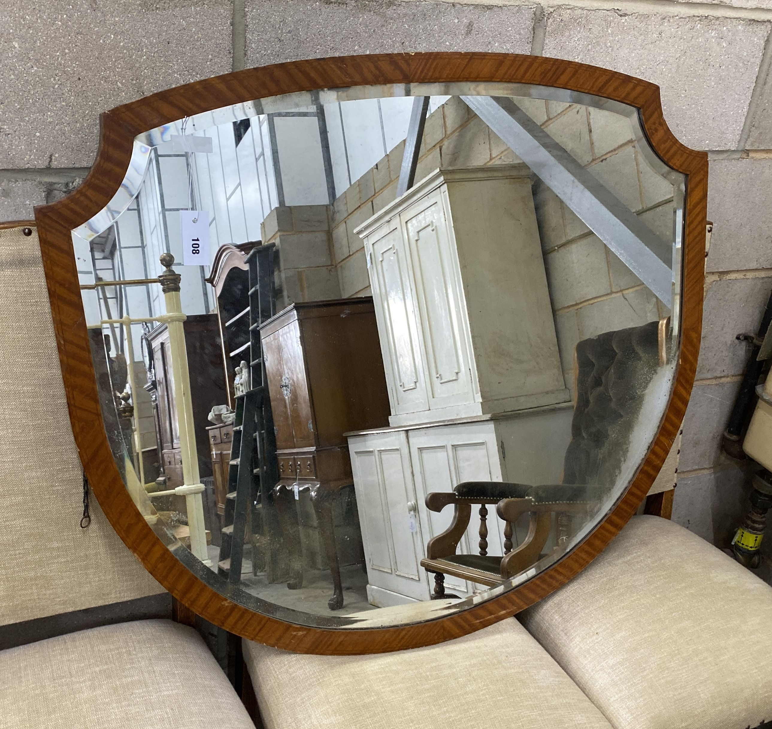 An Edwardian Sheraton style satinwood wall mirror